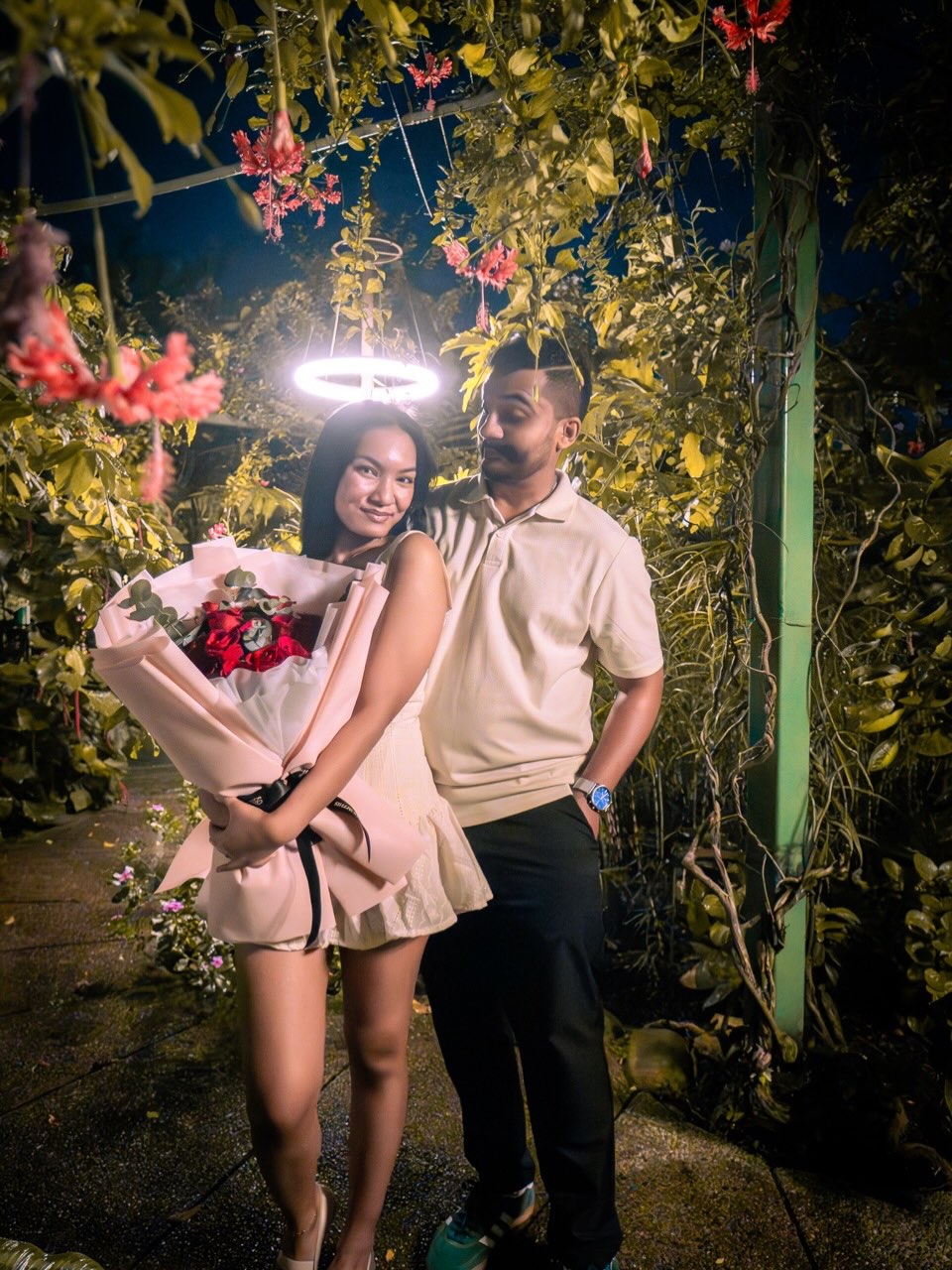 Zelda holding a bouquet of red roses right after the proposal